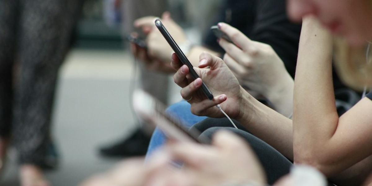 Hands holding smartphones at close range