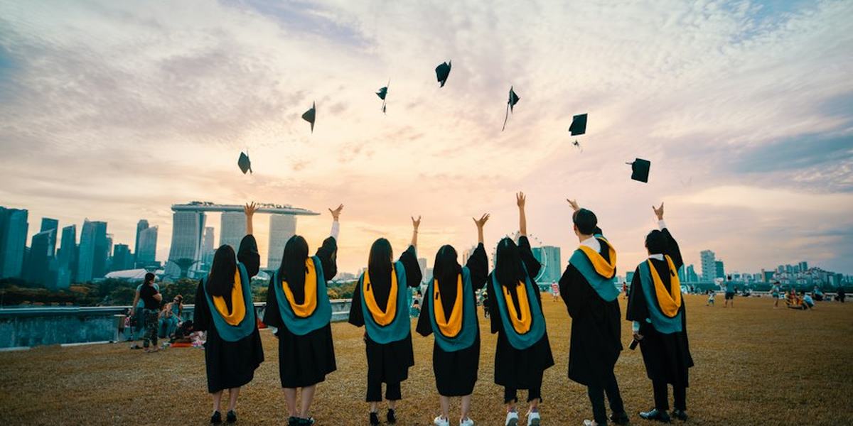 Graduates throwing their caps into the air