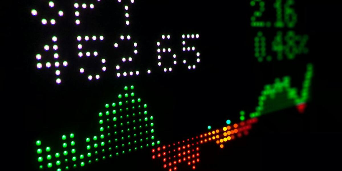 A stock ticker display showing a rising and falling chart