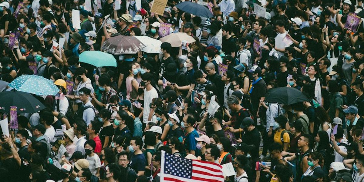 A United States flag held up in a crowd