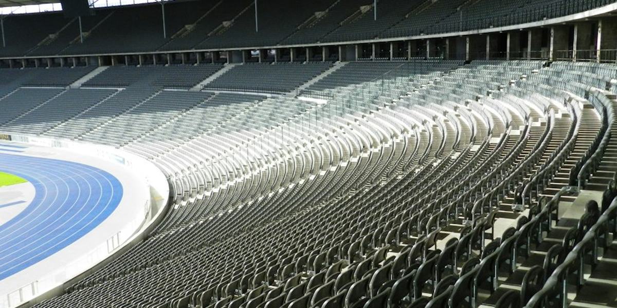 The empty tiered seating of a stadium