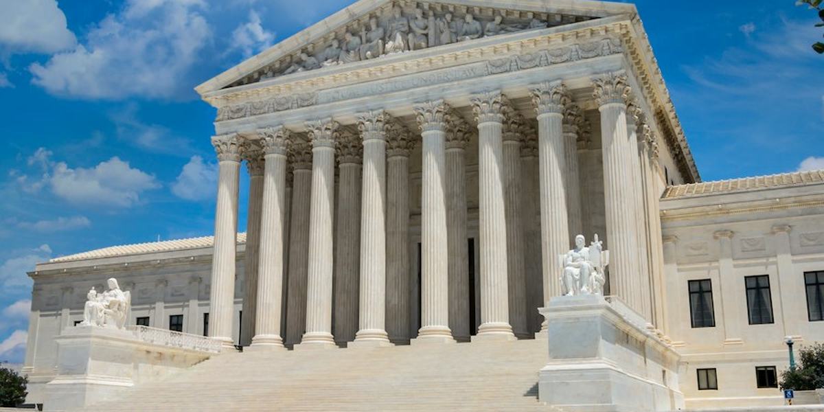 The facade of the Supreme Court building under a blue sky