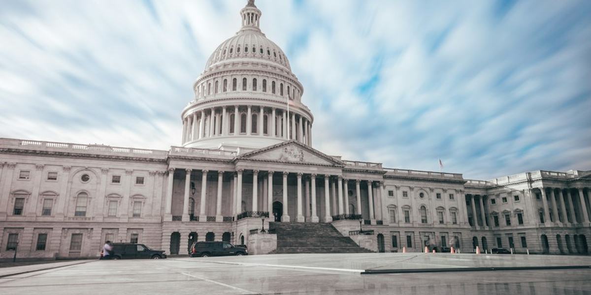 The dome of the United States Capitol against a bright sky
