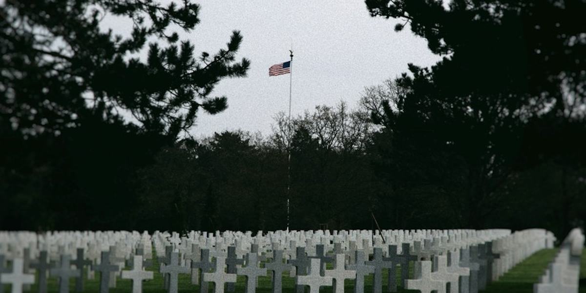 Rows of white headstones in a military cemetery