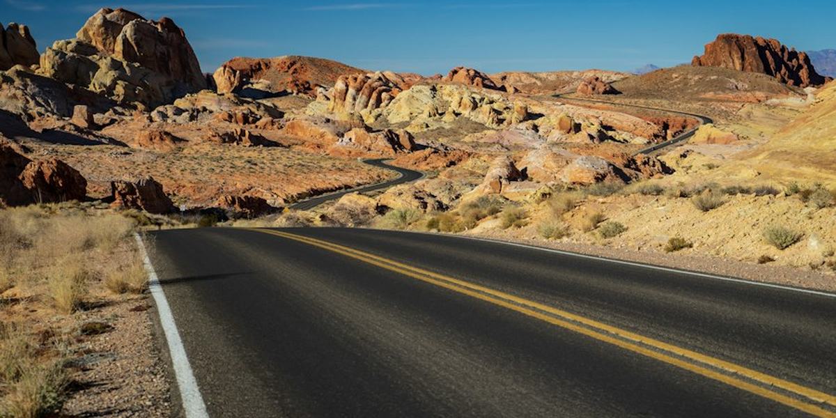 An empty highway running through desert country