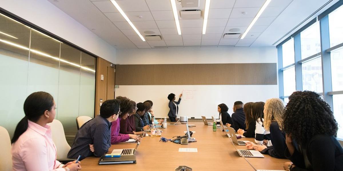 Colleagues seated around a boardroom table